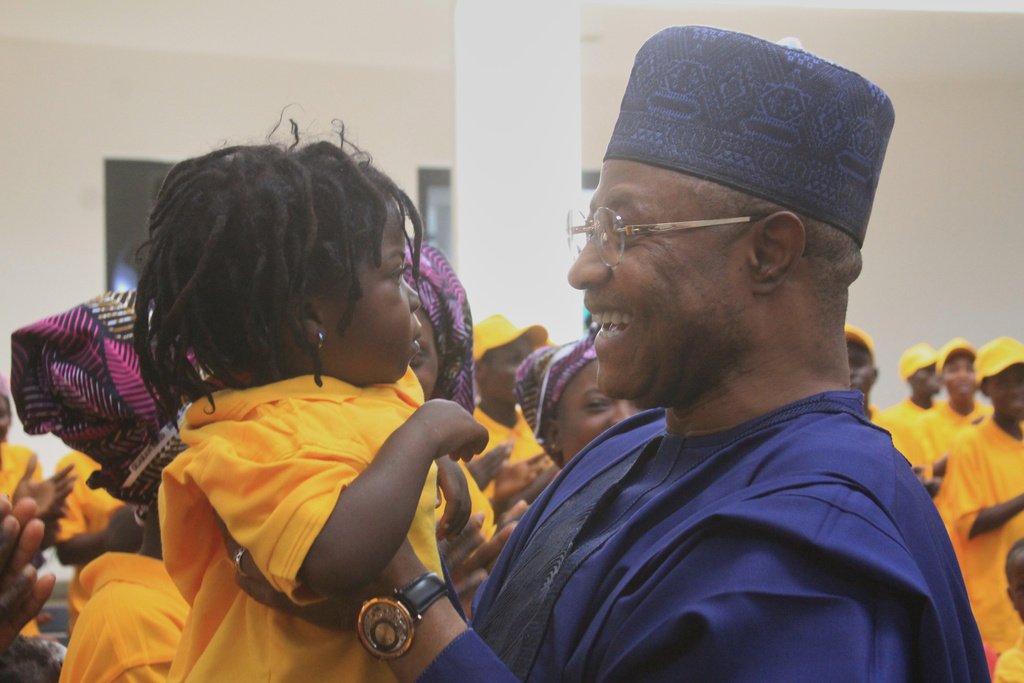Kaduna State Governor, Uba Sani, right, holds a child, freed with other worshipers, abducted by gunmen in Kurmin Wali, upon their arrival at the state government house in Kaduna, Nigeria, Thursday, Feb. 5, 2026. (AP Photo/Abel Omotosho)