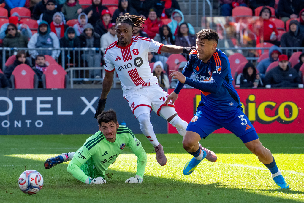 Toronto FC midfielder Malik Henry (78) and FC Cincinnati defender Gilberto Flores (3) chase as the ball as it gets past FC Cincinnati goalkeeper Roman Celentano (18) for a goal during the second half of an MLS soccer game in Toronto, Saturday, April 11, 2026. (Frank Gunn/The Canadian Press via AP)