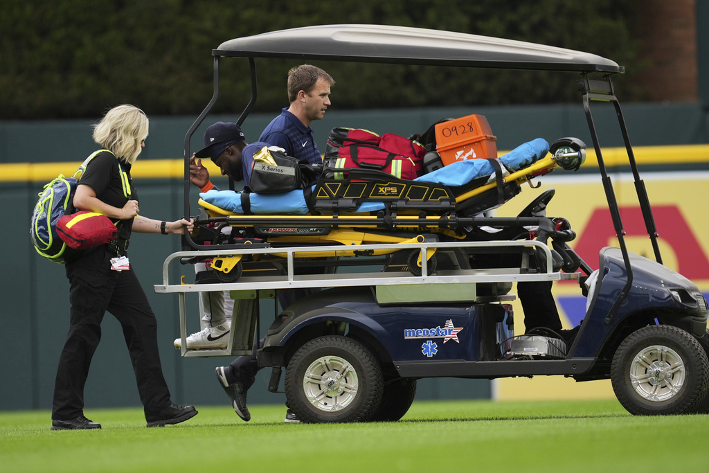 Houston Astros center fielder Taylor Trammell is transported off the field on a medical cart after being injured attempting to catch a Detroit Tigers' Dillon Dingler fly ball in the first inning during a baseball game Wednesday, Aug. 20, 2025, in Detroit. (AP Photo/Paul Sancya)
