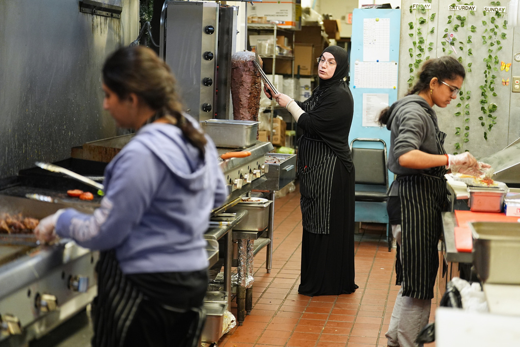 Emine Emanet, center, prepares food in the kitchen at the Jersey Kebab restaurant, Thursday, Jan. 29, 2026, in Collingswood, N.J. (AP Photo/Matt Rourke)