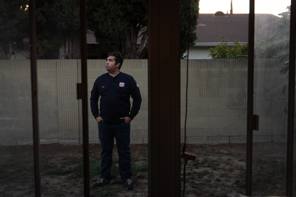 Wilfredo Cruz, an oil worker at the Phillips 66 Los Angeles Refinery Wilmington Plant, stands for a photo in the backyard of his home in Cerritos, Calif., Tuesday, Sept. 30, 2025. (AP Photo/Jae C. Hong)