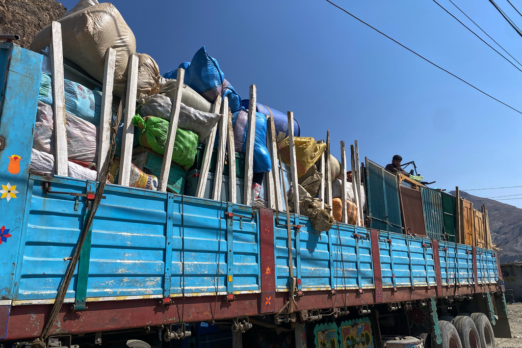 Trucks carrying Afghan refugees and their belongings are parked along roadside in a safer place following cross-border clashes between Pakistan and Afghan forces, at near Torkham border crossing point, Pakistan, Saturday, Feb. 28, 2026. (AP Photo/Maaz Awan)