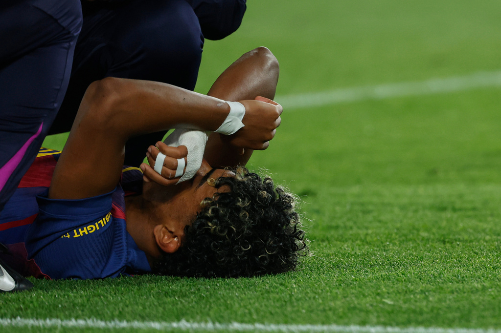 Barcelona's Lamine Yamal lies on the pitch injured during the Spanish La Liga soccer match between Barcelona and Celta Vigo in Barcelona, Spain, Wednesday, April 22, 2026. (AP Photo/Joan Monfort)