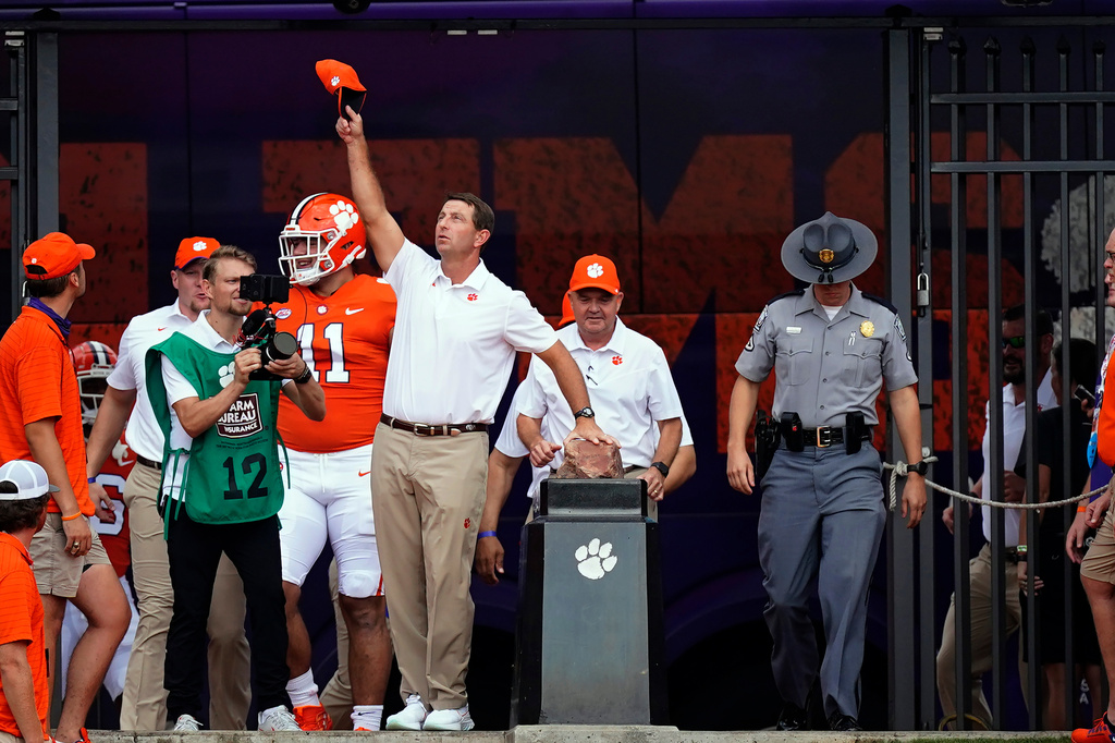 FILE - Clemson head coach Dabo Swinney touches Howard's Rock and waves to the crowd as he prepares to led his team onto the field for an NCAA college football game against Georgia Tech Saturday, Sept. 18, 2021, in Clemson, S.C. (AP Photo/John Bazemore, File)