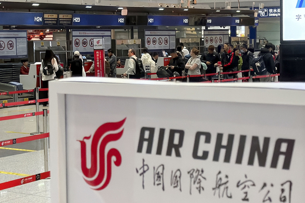 People line up in front of an Air China's counter for a direct flight between Beijing and North Korea's capital of Pyongyan, at Beijing Capital International Airport in Beijing Monday, March 30, 2026. (Iori Sagisawa/Kyodo News via AP)