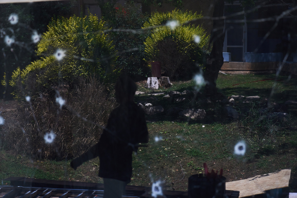 A person walks past the site struck by a rocket fired from Lebanon on Saturday in Kiryat Shmona, northern Israel, Sunday, May 31, 2026. (AP Photo/Ariel Schalit)