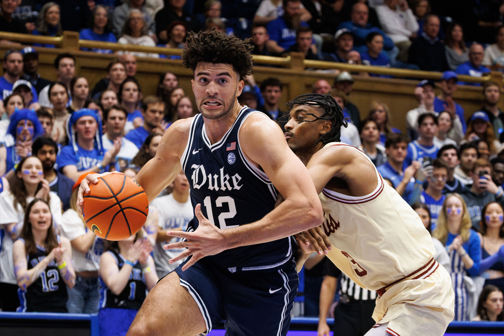 Duke's Cameron Boozer (12) handles the ball as Boston College's Aidan Shaw, right, defends during the second half of an NCAA college basketball game in Durham, N.C., Tuesday, Feb. 3, 2026. (AP Photo/Ben McKeown)