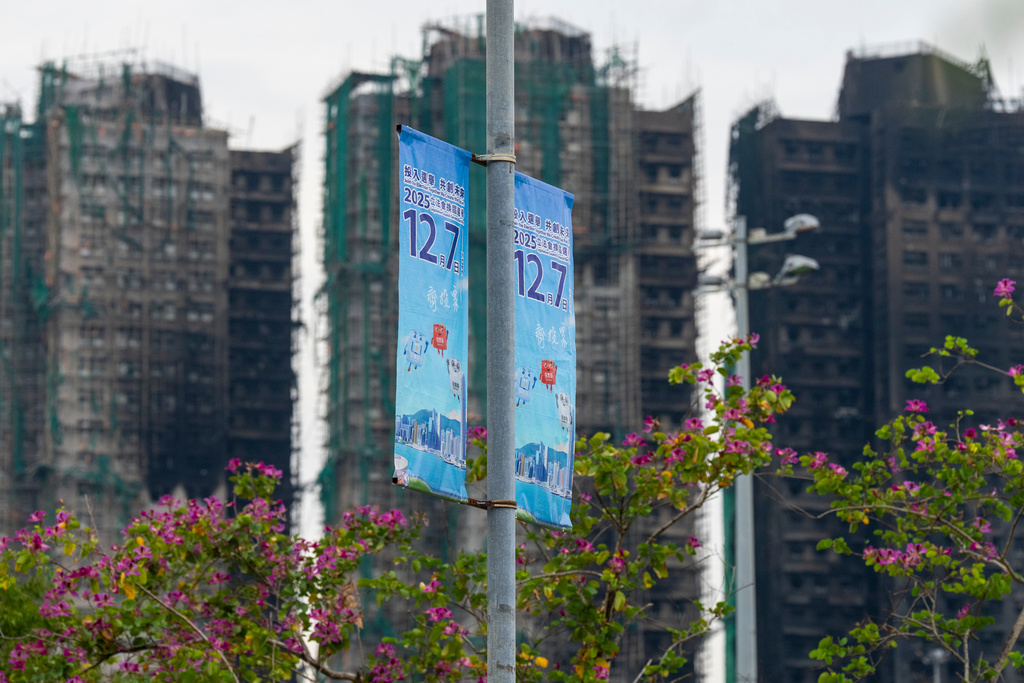Banners promoting the Hong Kong Legislative Council General Election hang near the site of the fire at Wang Fuk Court in the Tai Po district of Hong Kong on Wednesday, Dec. 3, 2025. (AP Photo/Chan Long Hei)