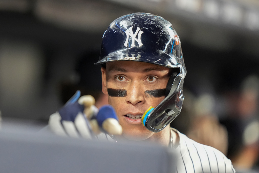 New York Yankees' Aaron Judge reacts in the dugout after hitting a three-run home run against the Toronto Blue Jays during the fourth inning of Game 3 of baseball's American League Division Series, Tuesday, Oct. 7, 2025, in New York. (AP Photo/Frank Franklin II)