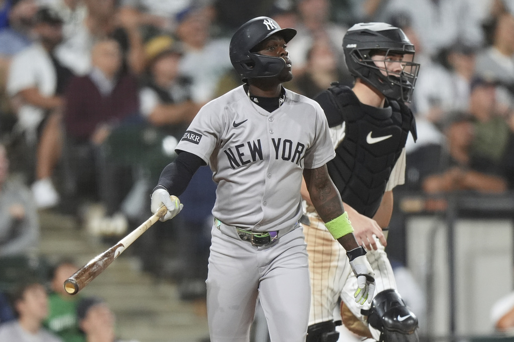 New York Yankees' Jazz Chisholm Jr., left, watches his sacrifice fly to Chicago White Sox right fielder Mike Tauchman during the fifth inning of a baseball game in Chicago, Thursday, Aug. 28, 2025. (AP Photo/Nam Y. Huh)