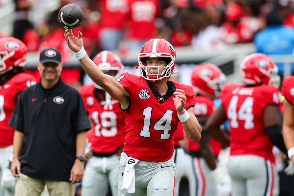 Georgia quarterback Gunner Stockton (14) throws during warm ups before an NCAA college football game against Vanderbilt, Saturday, Oct. 3, 2026, in Athens, Ga. (AP Photo/Colin Hubbard)