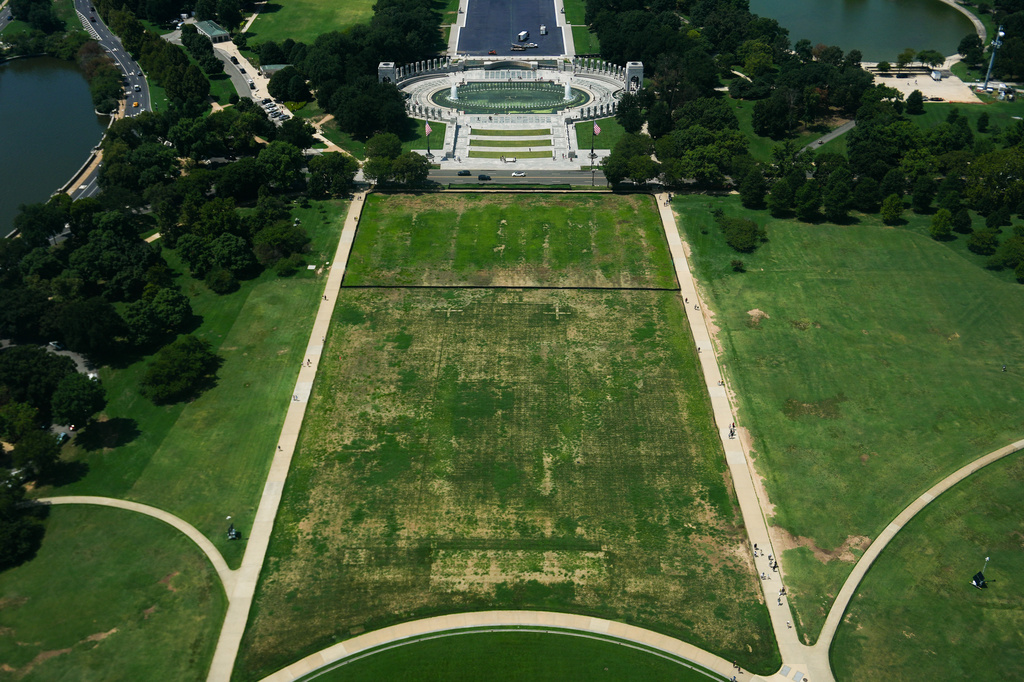 Damaged grass on the National Mall is seen from the Washington Monument, Monday, Aug. 17, 2026, in Washington, with the World War II Memorial in the background. (AP Photo/Julia Demaree Nikhinson)