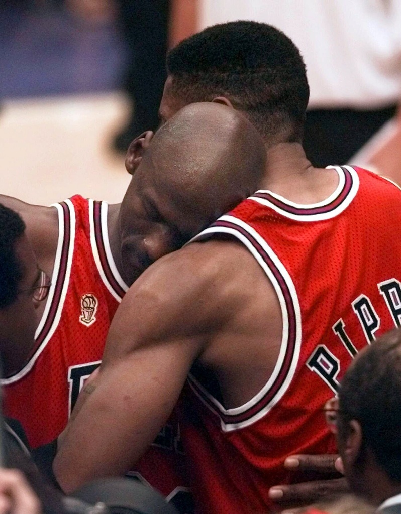FILE -The Chicago Bulls' Michael Jordan collapses in the arms of teammate Scottie Pippen, right, at the end of Game 5 of the NBA Finals against the Utah Jazz, June 11, 1997, in Salt Lake City. (AP Photo/Susan Ragan, File)