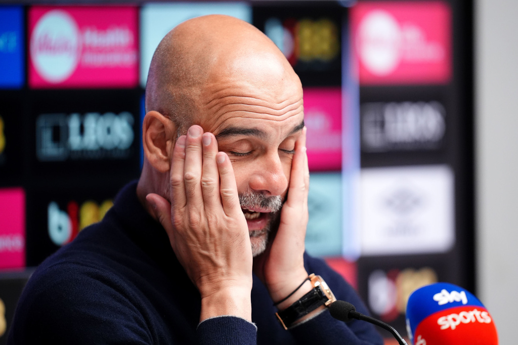 Manchester City manager Pep Guardiola rubs his face as he speaks to the media during a press conference following the English Premier League soccer match between AFC Bournemouth and Manchester City in Bournemouth, England, Tuesday, May 19, 2026. (John Walton/PA via AP)
