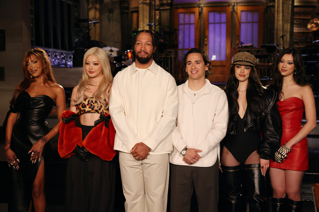 This image released by NBC shows host Jalen Brunson, third from left, Marcello Hernández, fourth from left, with musical guests Lara Raj, Yoonchae, Daniela Avanzini, and Megan Skiendiel of Katseye during promos for "Saturday Night Live" on Thursday Sept. 24, 2026, in New York. (Rosalind O'Connor/NBC via AP)