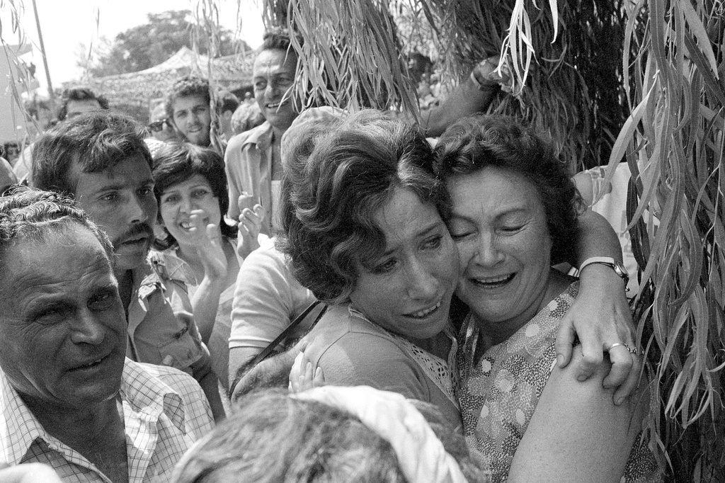 FILE - A mother and her daughter embrace when the latter arrived at Tel Aviv's Ben Gurion Airport after Israeli paratroopers freed her and other hostages aboard a Air France jet at Uganda's Entebbe Airport earlier in the day, July 4, 1976. (AP Photo/Nash, File)