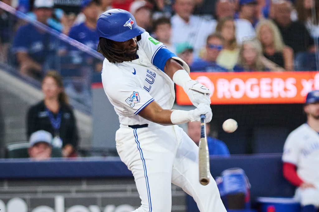 Toronto Blue Jays' Charles McAdoo hits a home run against the Boston Red Sox during the fifth inning of a baseball game in Toronto, Monday, Aug. 10, 2026. (Sammy Kogan/The Canadian Press via AP)
