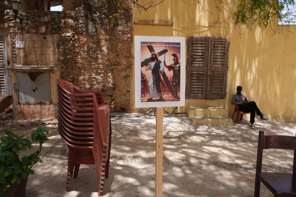 A poster promoting a Passion of Christ reenactment is displayed in the courtyard of Saint Charles church on Goree Island, Senegal, Friday, April 3, 2026. (AP Photo/Misper Apawu)