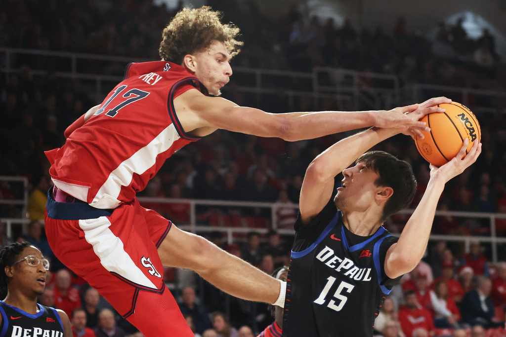 DePaul center Fabian Flores (15) shoots over St. John's forward Rubén Prey (17) during the first half of an NCAA college basketball game, Tuesday, Dec. 16, 2025, in New York. (AP Photo/Heather Khalifa)