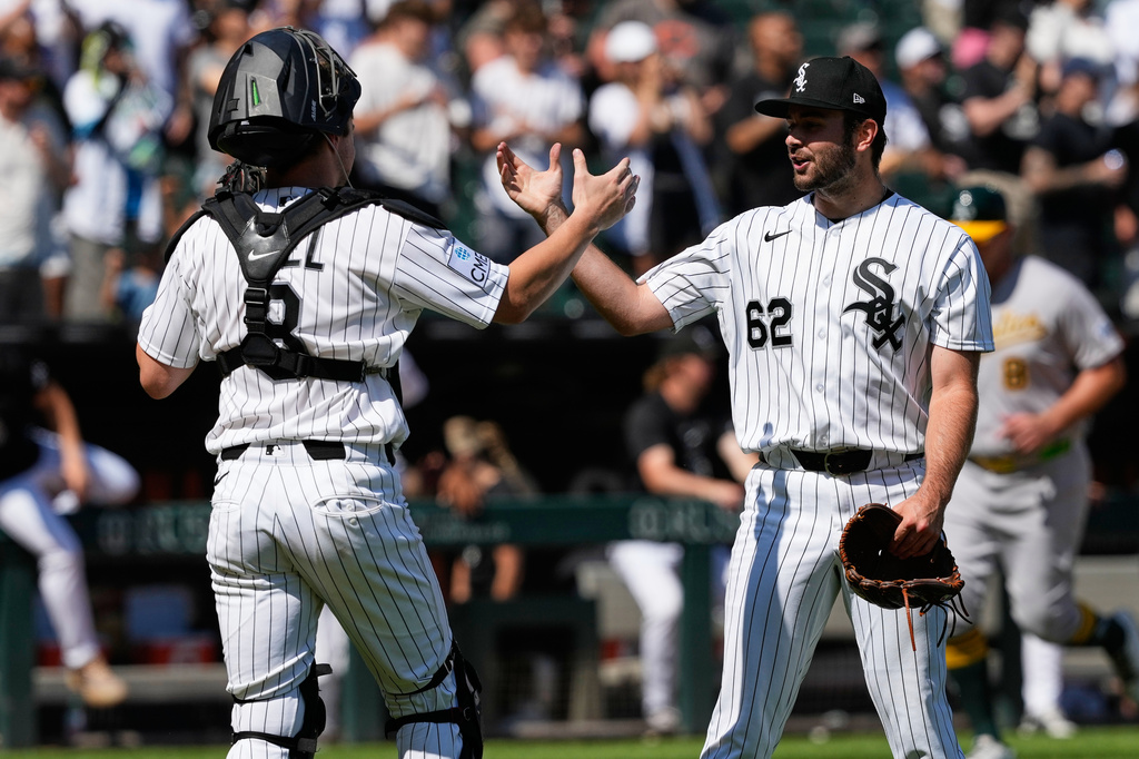 Chicago White Sox catcher Kyle Teel, left, celebrates with relief pitcher Tyler Schweitzer after the White Sox defeated the Athletics in a baseball game in Chicago, Sunday, July 12, 2026. (AP Photo/Nam Y. Huh)
