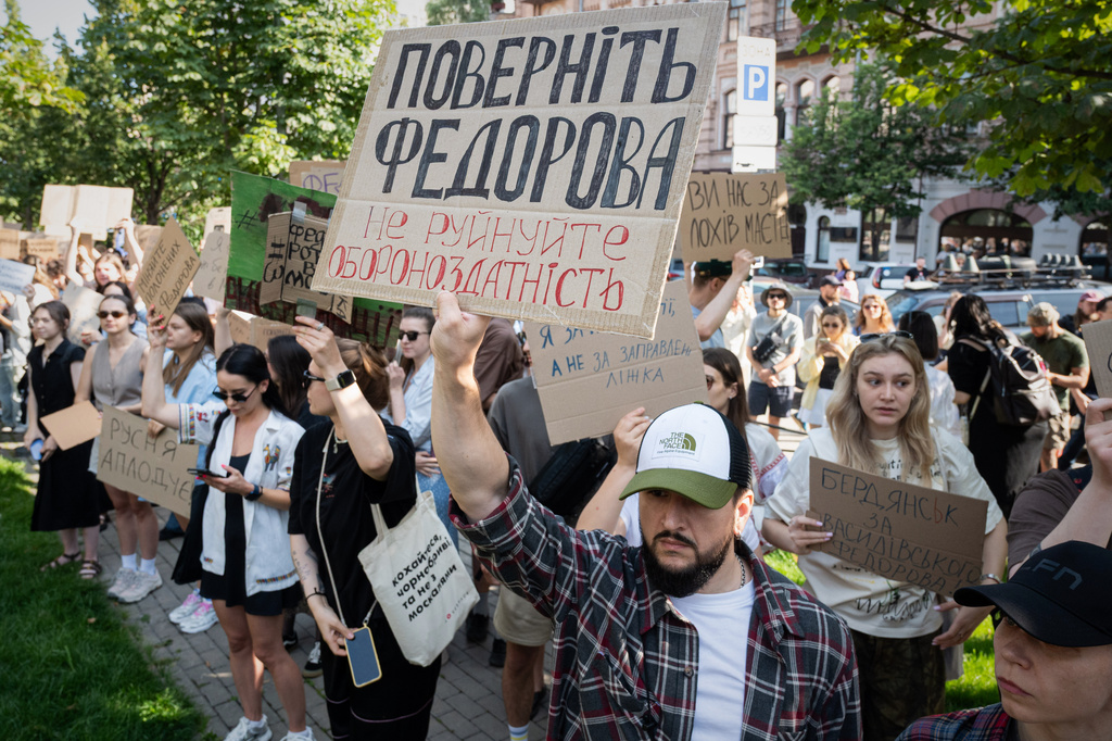 Ukranians gather to denounce President Volodymyr Zelenskyy's decision to dismiss Defense Minister Mykhailo Fedorov after six months in the post, Kyiv, Ukraine, Thursday, July 16, 2026. Placard reads: Bring back Fedorov. Do not destroy defense capability. (AP Photo/Danylo Antoniuk)