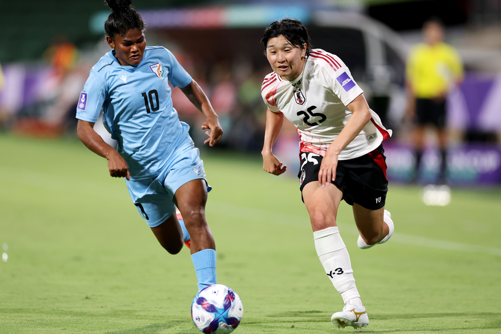 Japan's Remina Chiba, right, and India's Pyari Xaxa battle for the ball during the Women's Asian Cup soccer match between Japan and India in Perth, Australia, Saturday, March 7, 2026. (Colin Murtyt/AAPImage via AP)