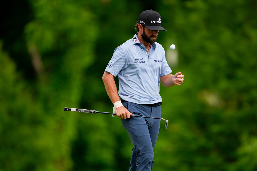 Cameron Young flips his golf ball on the 12th green during third round of the Truist Championship golf tournament at the Quail Hollow Club, Saturday, May 9, 2026, in Charlotte, N.C. (AP Photo/Chris Carlson)