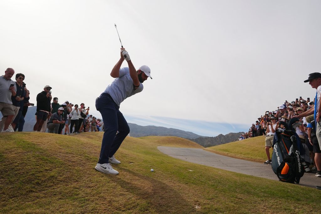 Scottie Scheffler hits his ball out of the rough on the ninth hole during the final round of the American Express golf event on the Pete Dye Stadium Course at PGA West Sunday, Jan. 25, 2026, in La Quinta, Calif. (AP Photo/Ross D. Franklin)