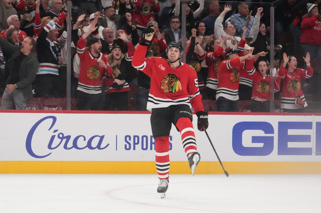 Chicago Blackhawks defenseman Artyom Levshunov (55) celebrates a goal by center Anton Frondell against the St. Louis Blues during the second period of an NHL hockey game, Tuesday, Oct. 6, 2026, in Chicago. (AP Photo/David Banks)