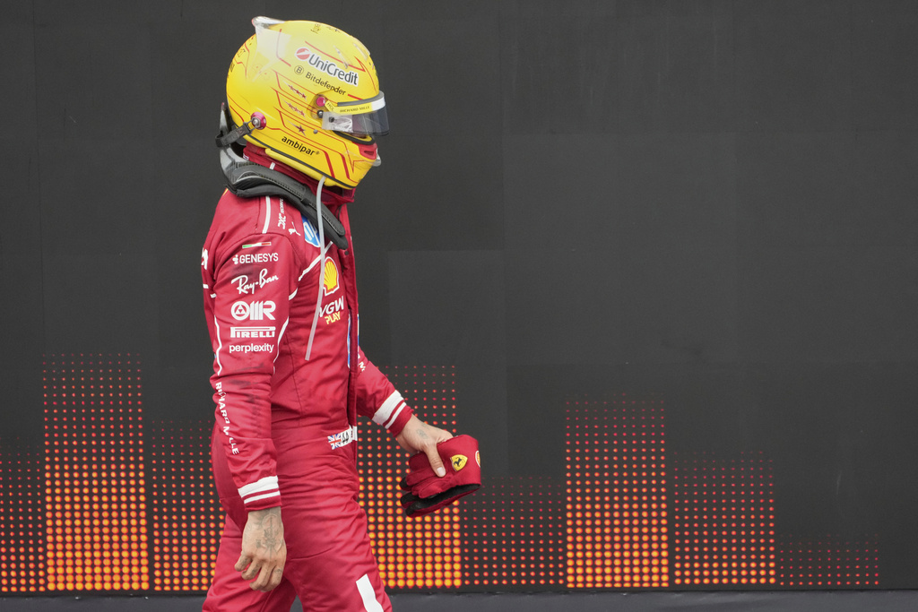 Ferrari driver Lewis Hamilton of Britain walks through the pit lane after the Azerbaijan Formula One Grand Prix in Baku, Azerbaijan, Sunday, Sept. 21, 2025. (AP Photo/Darko Bandic)