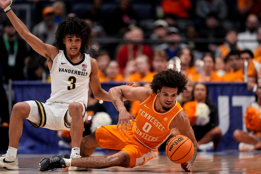 Tennessee guard Ja'kobi Gillespie (0) and Vanderbilt guard Tyler Tanner (3) vie for a loose ball during the second half of an NCAA college basketball game in the quarterfinal round of the Southeastern Conference tournament, Friday, March 13, 2026, in Nashville, Tenn. (AP Photo/George Walker IV)