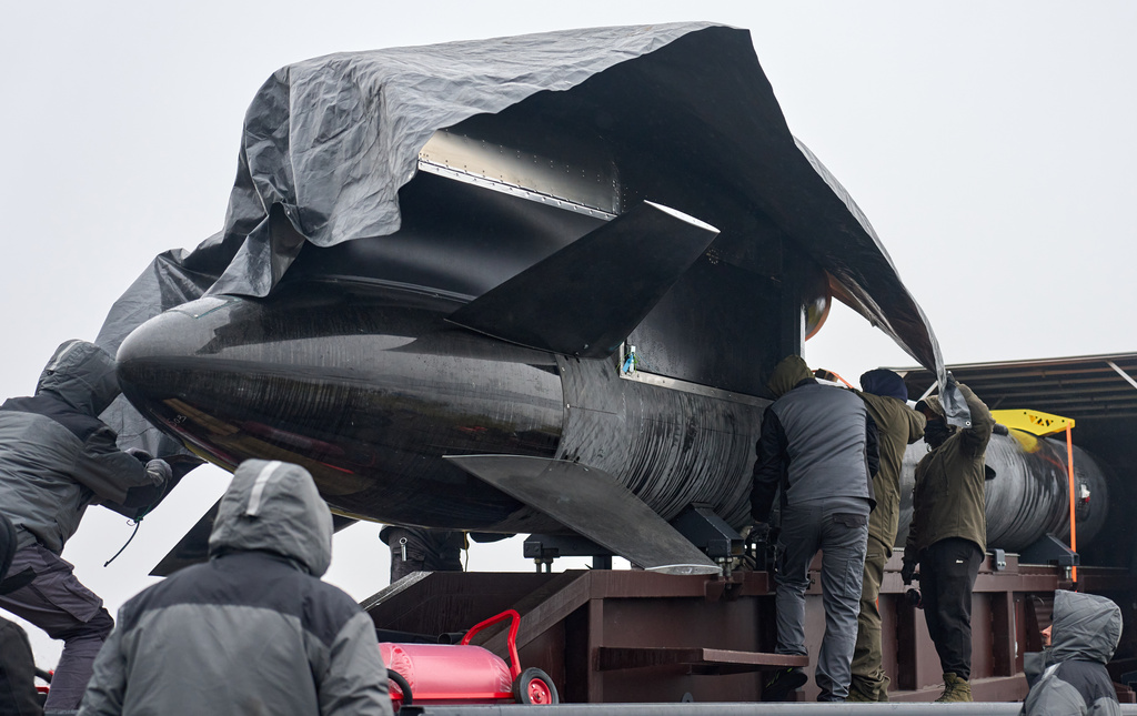 Workers and military inspect Ukrainian Fire Point's Flamingo missiles during handover to the military in an undisclosed location in Ukraine Thursday, Dec. 4, 2025. (AP Photo/Efrem Lukatsky)