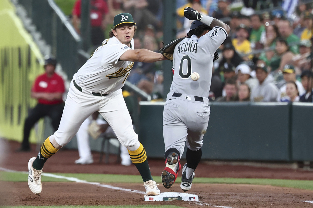 Athletics first baseman Nick Kurtz, left, attempts to get Chicago White Sox's Luisangel Acuña (0) out at first base during the fourth inning of a baseball game Friday, April 17, 2026, in West Sacramento, Calif. (AP Photo/Sara Nevis)