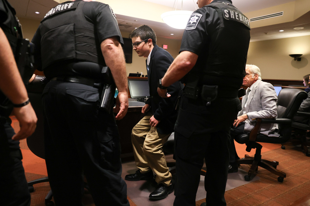 Colt Gray, the 16-year-old convicted in the Apalachee High School shooting, stands to be handcuffed following his sentencing at Barrow County Superior Court in Winder, Ga., on Tuesday, July 28, 2026. (Arvin Temkar/Atlanta Journal-Constitution via AP)