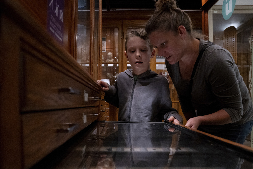 Lincoln Stollenwerk, 8, and Felice Leibowitz, 43, look at a display on objects swallowed by people at the Mütter Museum on Thursday, Aug. 21, 2025, in Philadelphia. (AP Photo/Mingson Lau)