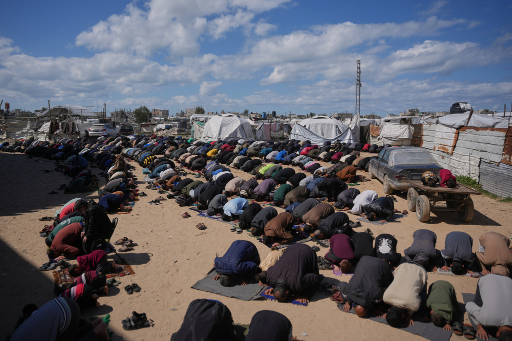 Muslim worshippers perform Friday prayers during the holy month of Ramadan outside the destroyed Al-Albani Mosque, in Khan Younis, southern Gaza Strip, Friday, Feb. 27, 2026. (AP Photo/Abdel Kareem Hana)