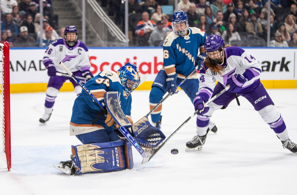 Minnesota Frost Dominique Petrie (14) shoots on Vancouver Goldeneyes goalie Emerance Maschmeyer (38) as Sophie Jaques (16) and Kendall Coyne-Schofield (26) look on during the first period of an PWHL game in Edmonton, Saturday, Dec. 27, 2025. (Amber Bracken/The Canadian Press via AP)