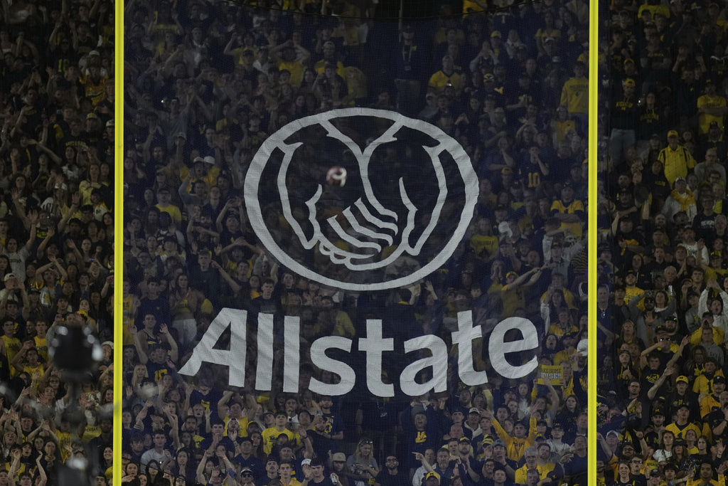 An Allstate advertisement is seen on the field goal net as New Mexico place kicker Luke Drzewiecki makes a field goal during the first half of an NCAA college football game against Michigan, Saturday, Aug. 30, 2025, in Ann Arbor, Mich. (AP Photo/Ryan Sun)