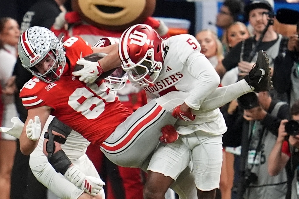 Indiana's D'Angelo Ponds stops Ohio State's Max Klare during the second half of the Big Ten championship NCAA college football game in Indianapolis, Saturday, Dec. 6, 2025. (AP Photo/Michael Conroy)