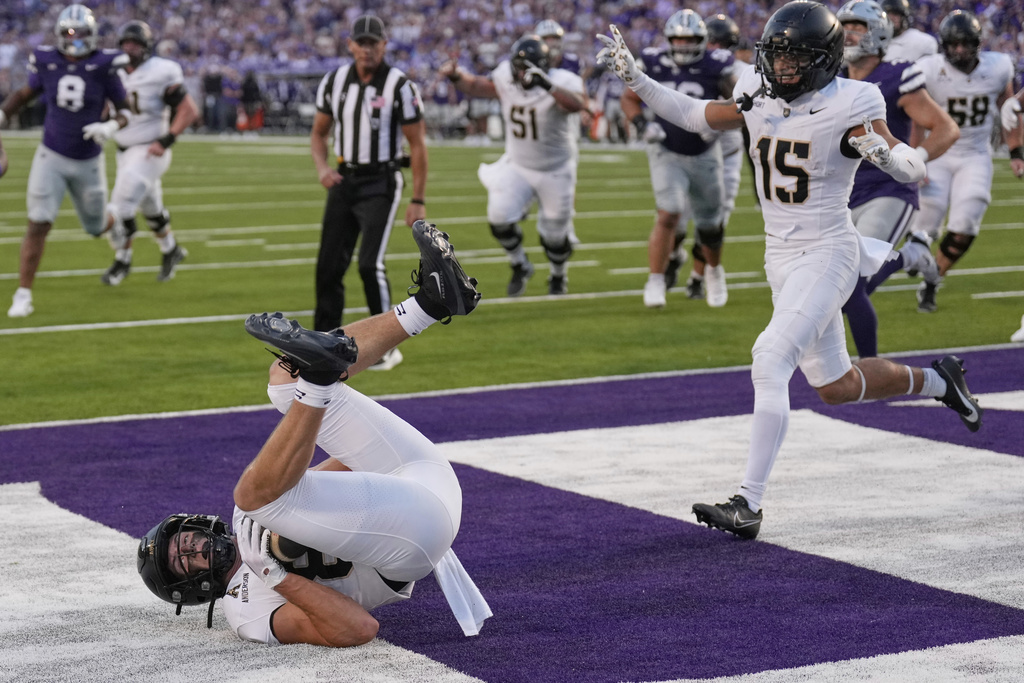 Army wide receiver Brady Anderson, bottom left, catches a pass to score a touchdown during the first half of an NCAA college football game against Kansas State, Saturday, Sept. 6, 2025, in Manhattan, Kan. (AP Photo/Charlie Riedel)