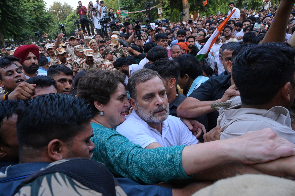 India's opposition Congress party leader Rahul Gandhi, center, and his sister, fellow lawmaker Priyanka Gandhi Vadra, jostle with police during a protest demanding the resignation of Chief Election Commissioner Gyanesh Kumar in New Delhi, India, Wednesday, Oct. 7, 2026. (AP Photo/Vipin)