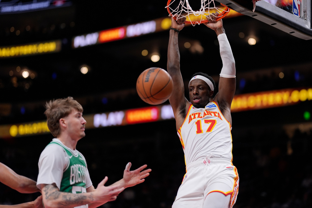 Atlanta Hawks forward Onyeka Okongwu (17) dunks against the Boston Celtics in the first half of an NBA basketball game, Monday, March 30, 2026, in Atlanta. (AP Photo/Mike Stewart)