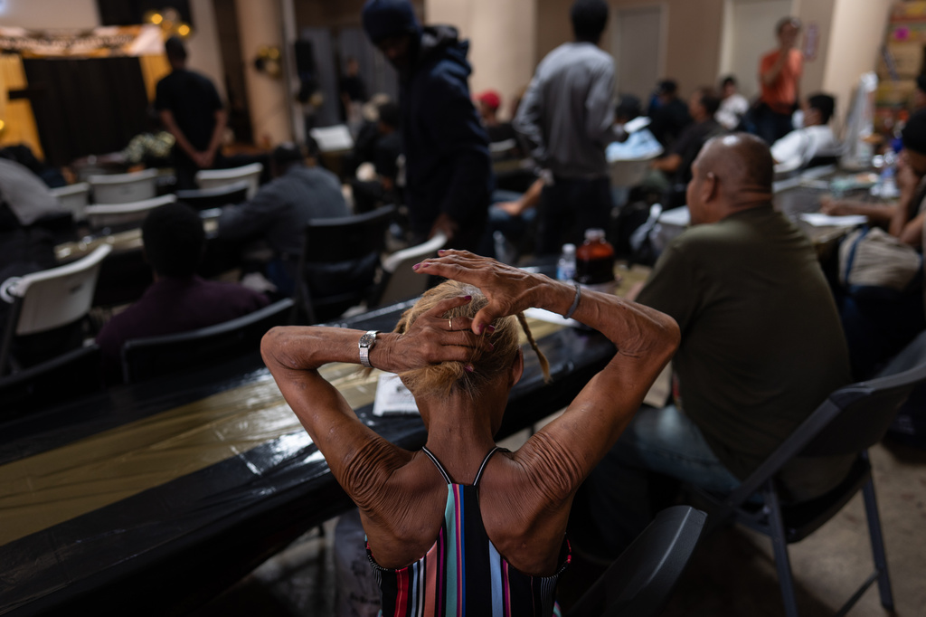 A woman in the audience fixes her hair before the start of Skid Row's inaugural talent show in downtown Los Angeles, Saturday, Sept. 19, 2026. (AP Photo/Jae C. Hong)