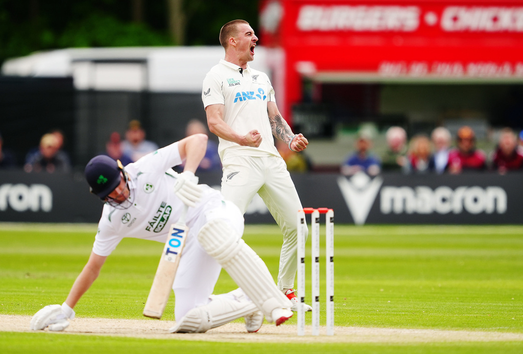 New Zealand's Blair Tickner celebrates after bowling to Ireland's Harry Tector, left, who was caught out by Tom Latham on day three of the test match in Belfast, Northern Ireland, Friday May 29, 2026. (Brian Lawless/PA via AP)