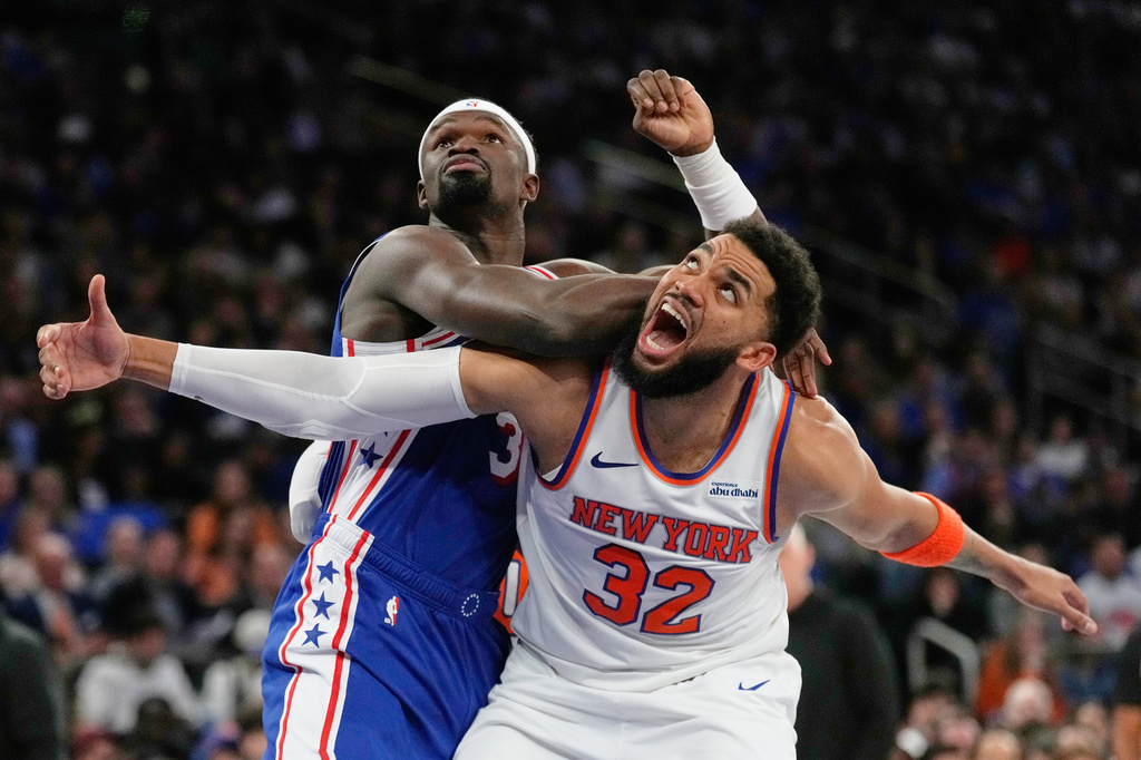 Philadelphia 76ers' Adem Bona, top, fouls New York Knicks' Karl-Anthony Towns during the second half of Game 1 in a second-round NBA basketball playoffs series Monday, May 4, 2026, in New York. (AP Photo/Seth Wenig)