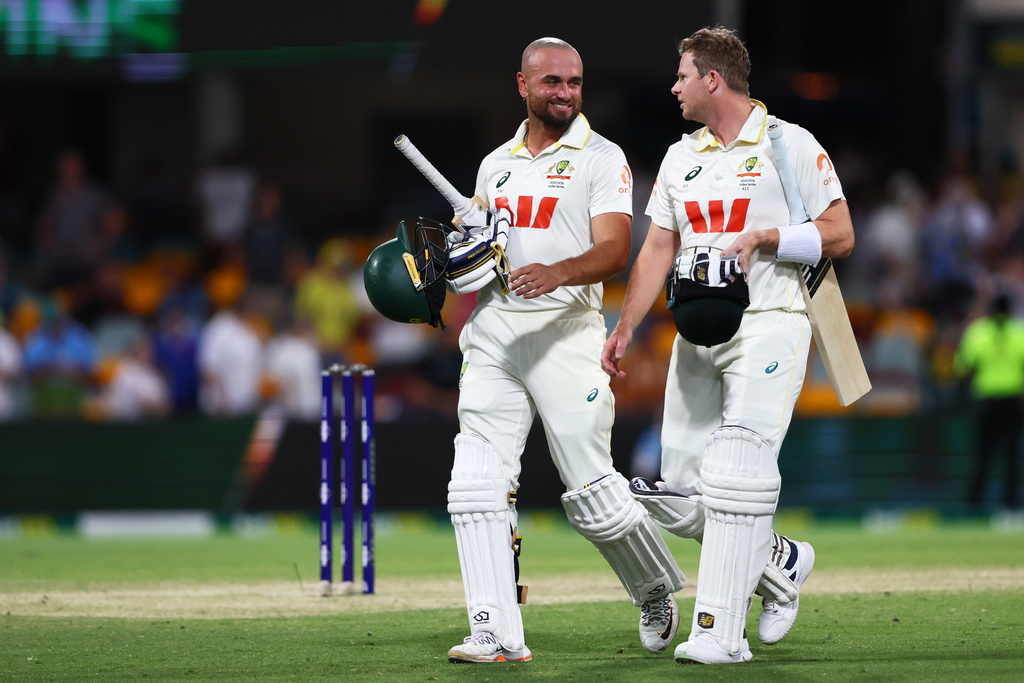 Australia's Jake Weatherald, left, and Australia's captain Steve Smith walk off the field after winning the second Ashes cricket test match between Australia and England in Brisbane, Sunday, Dec. 7, 2025.. (AP Photo/Tertius Pickard)