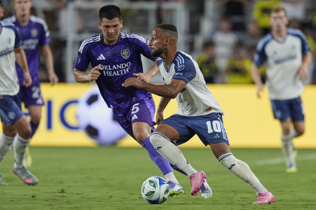 Nashville SC midfielder Hany Mukhtar (10) kicks the ball past Orlando City midfielder César Araújo (5) during the first half of an MLS soccer match Saturday, Aug. 23, 2025, in Nashville, Tenn. (AP Photo/George Walker IV)