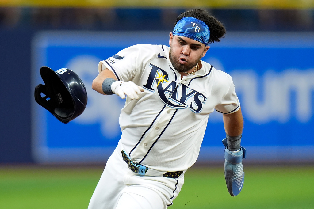 Tampa Bay Rays' Jonathan Aranda loses his helmet as he scores on an RBI double by Yandy Díaz off Baltimore Orioles pitcher Kyle Bradish during the first inning of a baseball game Tuesday, May 19, 2026, in St. Petersburg, Fla. (AP Photo/Chris O'Meara)