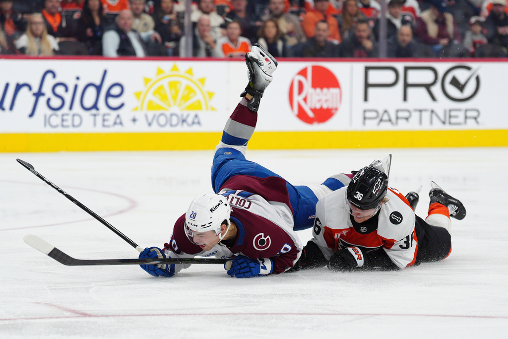 Philadelphia Flyers' Emil Andrae, right, and Colorado Avalanche's Ross Colton, left, collide during the third period of an NHL hockey game, Sunday, Dec. 7, 2025, in Philadelphia. (AP Photo/Derik Hamilton)