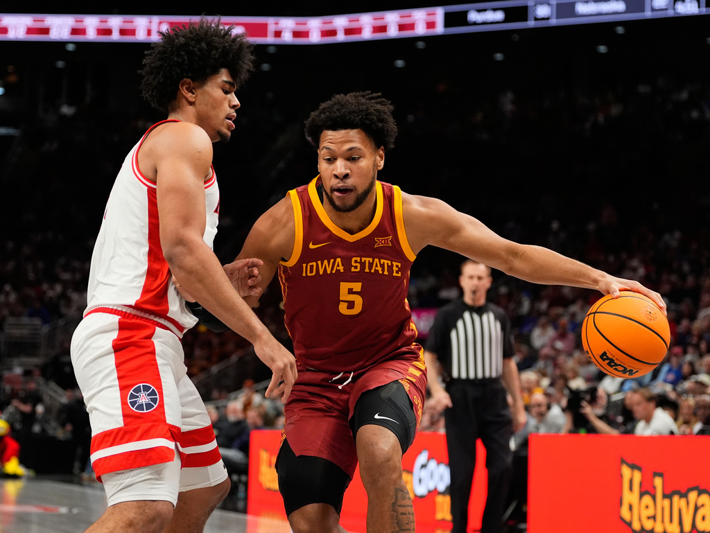 Iowa State's Joshua Jefferson (5) dribbles as Arizona's Koa Peat defends during the first half of an NCAA college basketball game in the semifinal round of the Big 12 Conference tournament Friday, March 13, 2026, in Kansas City, Mo. (AP Photo/Charlie Riedel)